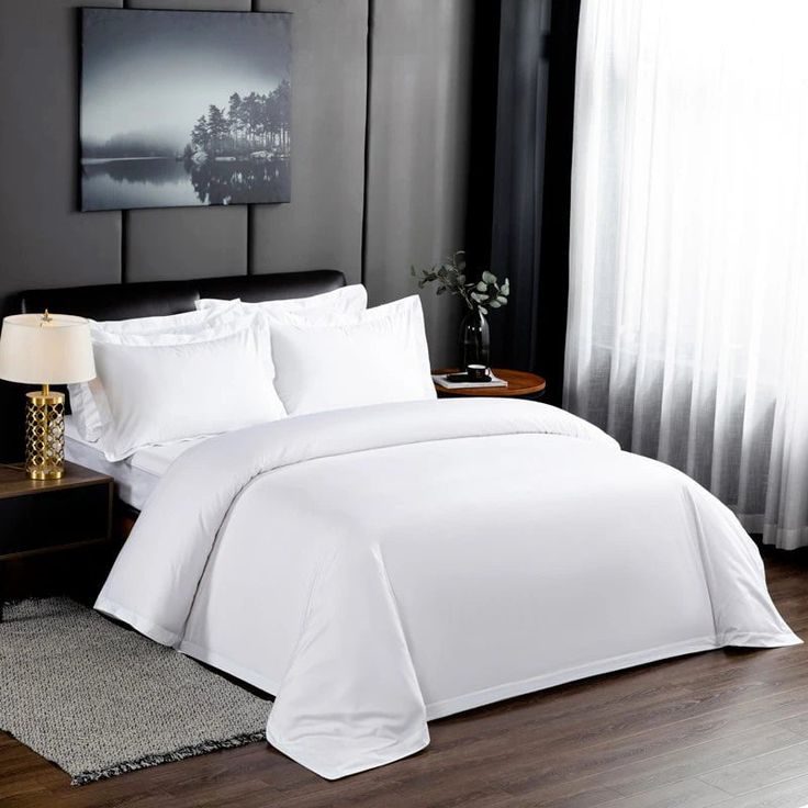 Hotel bed dressed in white cotton linen